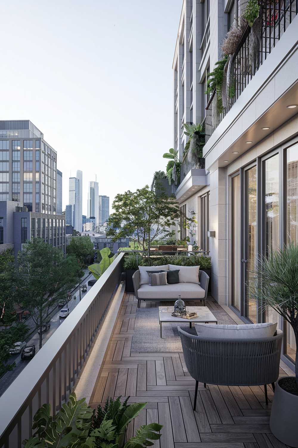 A large balcony with a stylish design and decor. The balcony has a white railing and is adorned with green plants. There is a modern sofa, a coffee table, and a few potted plants. The floor is made of wooden planks. The background reveals a cityscape with tall buildings. The overall ambiance is serene and urban.