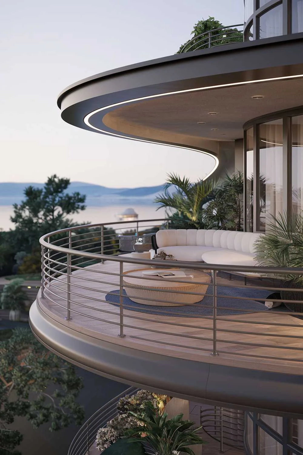 24 Must-See Modern Balcony Design Ideas for Stylish Living 8 A modern balcony design and decor. The balcony has a wooden floor and is surrounded by a railing with a sleek, curved design. There's a white couch, a round wooden table, and a few potted plants on the balcony. The railing is a dark grey colour. The background reveals a serene landscape with mountains, trees, and a body of water.